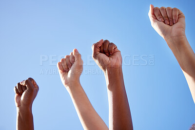 Buy stock photo Shot of an unrecognisable group of women raising their hands in strength outside