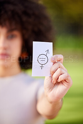 Buy stock photo Shot of a young woman holding a card in protest in a park