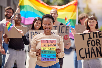 Buy stock photo Shot of a group of young people protesting for lgbtq rights