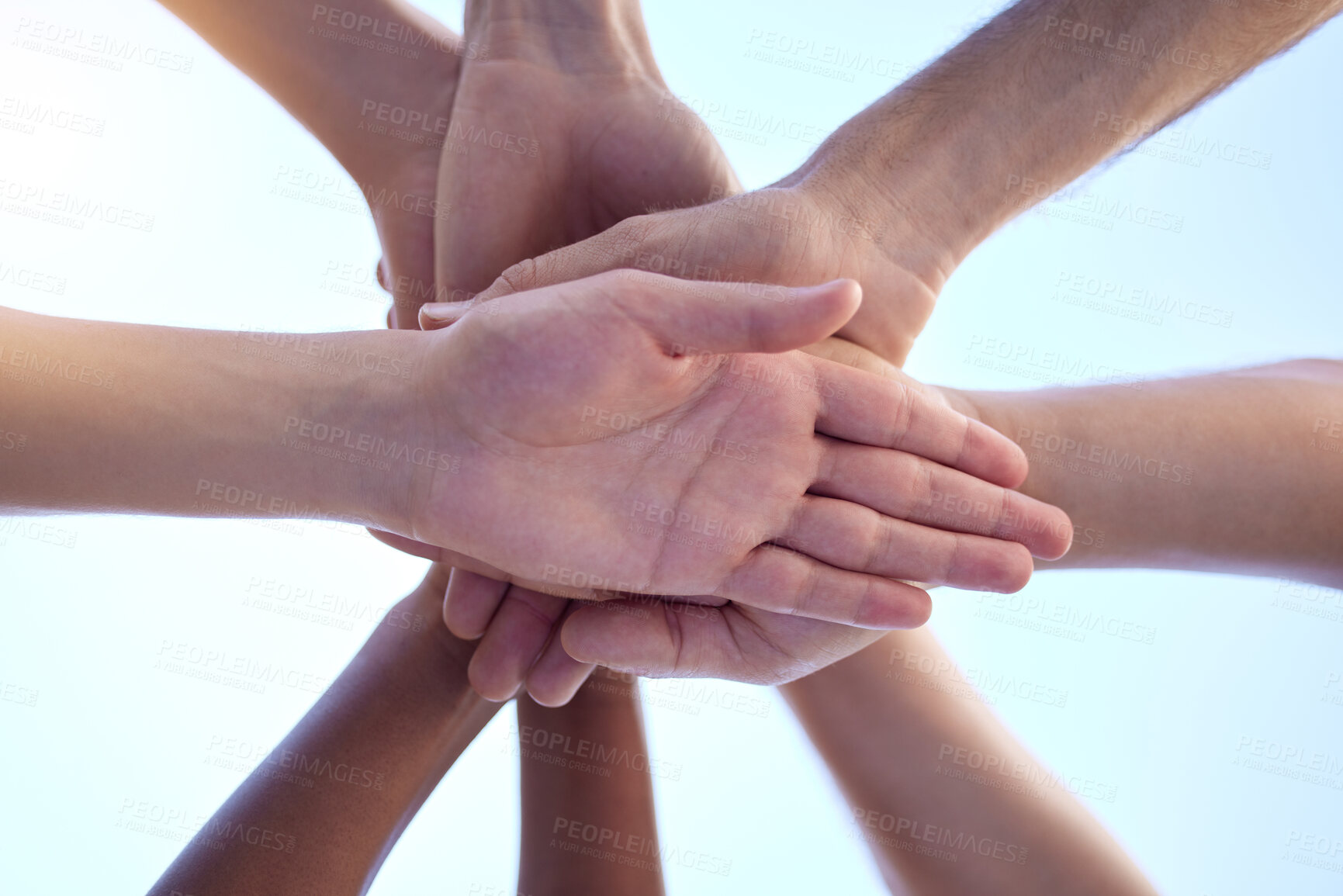 Buy stock photo Shot of a group of people with their hands stacked together