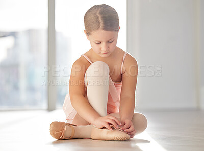 Buy stock photo Shot of a young ballerina getting ready for practice in a dance studio