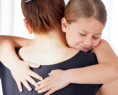 Buy stock photo Shot of a ballet teacher hugging her student in a dance studio