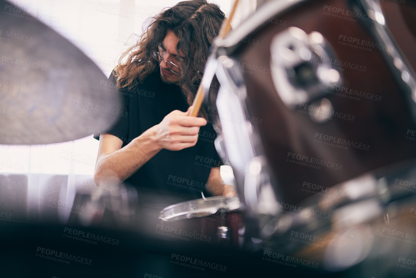 Buy stock photo Man, drummer and artist in house with drums for band as musician in playing an instrument. Male person, home and practice as creative for ideas, song or lyrics for online content or live performance