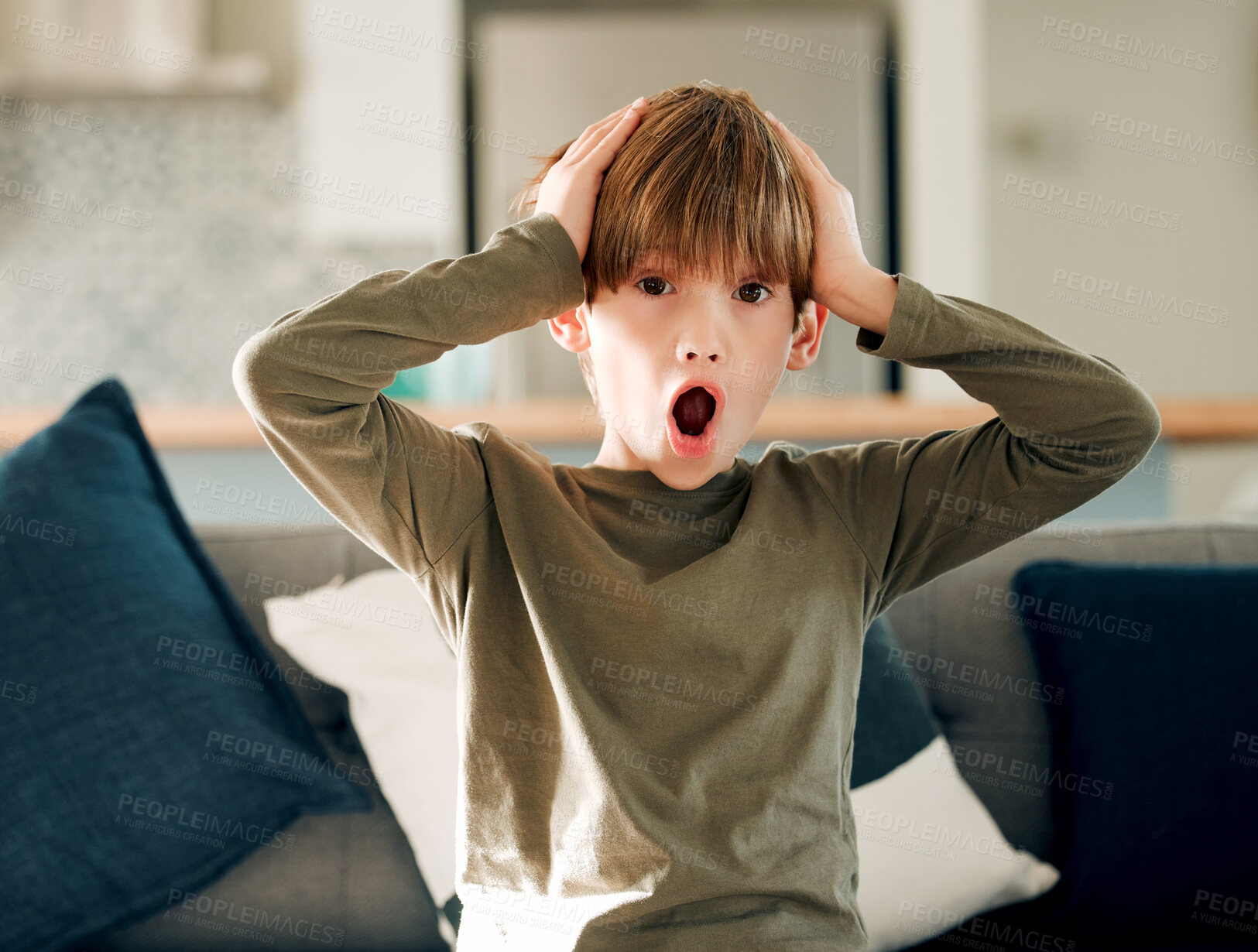 Buy stock photo Surprise, portrait and child in home with wow, shocked and amazed emoji gesture in living room. Young boy, news and gossip on a sofa with open mouth, omg and mind blown from announcement in lounge