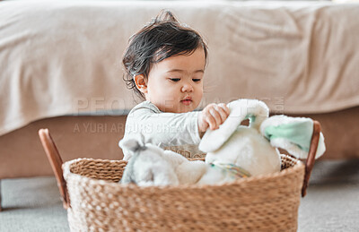 Buy stock photo Shot of an adorable baby girl sitting in a basket at home