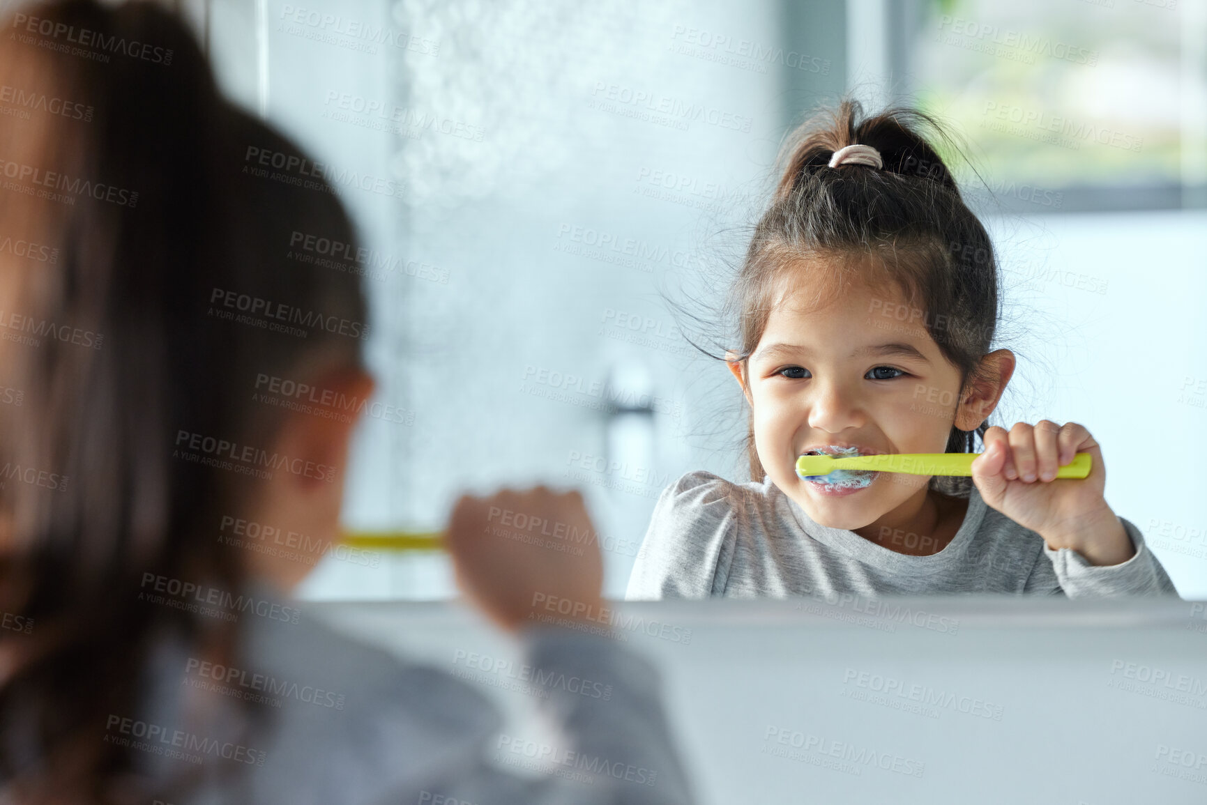 Buy stock photo Girl child, mirror and brushing teeth in bathroom for hygiene with wellness, growth and gingivitis prevention in home. Young kid, reflection and tooth cleaning with development, foam and healthy gums