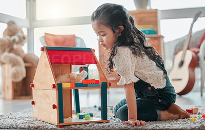 Buy stock photo Girl, dollhouse and child thinking in home, games and fantasy for brain development on floor. Female person, toys and blocks on ground for entertainment, ideas and toddler for education or learning