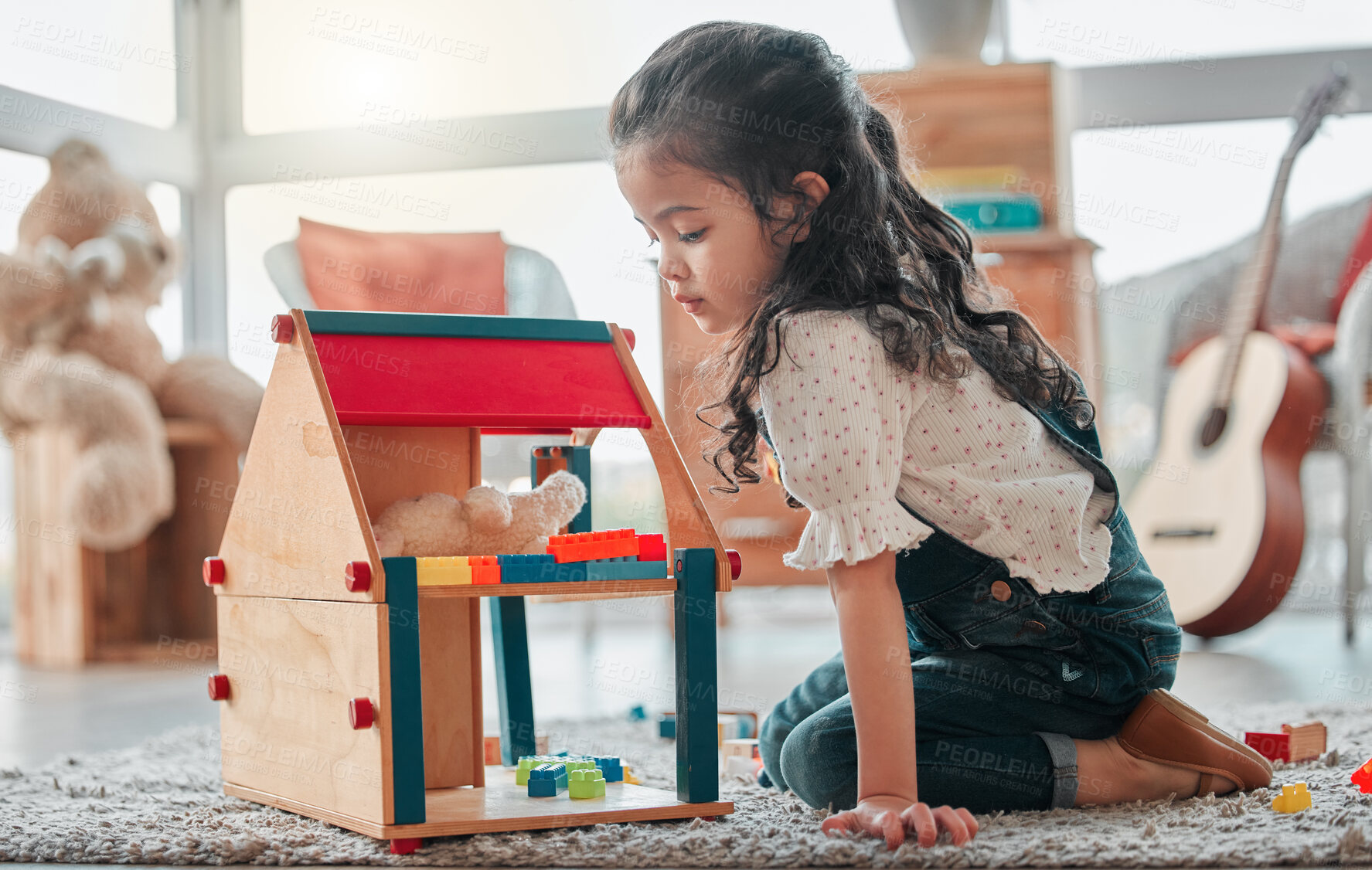 Buy stock photo Girl, dollhouse and child thinking in home, games and fantasy for brain development on floor. Female person, toys and blocks on ground for entertainment, ideas and toddler for education or learning