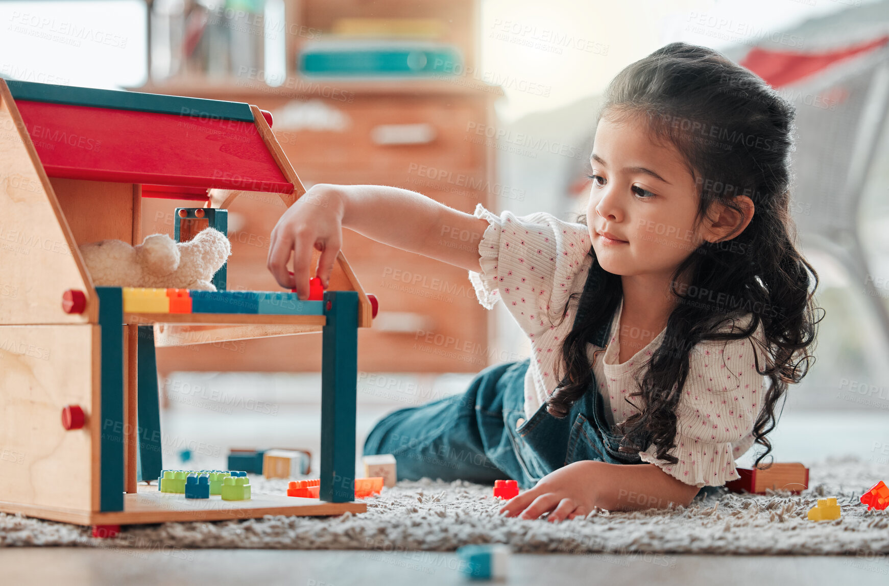 Buy stock photo Girl, dollhouse and child play on floor, games and fantasy for brain development in home. Female person, toys and blocks on ground for entertainment, growth and toddler for education or learning