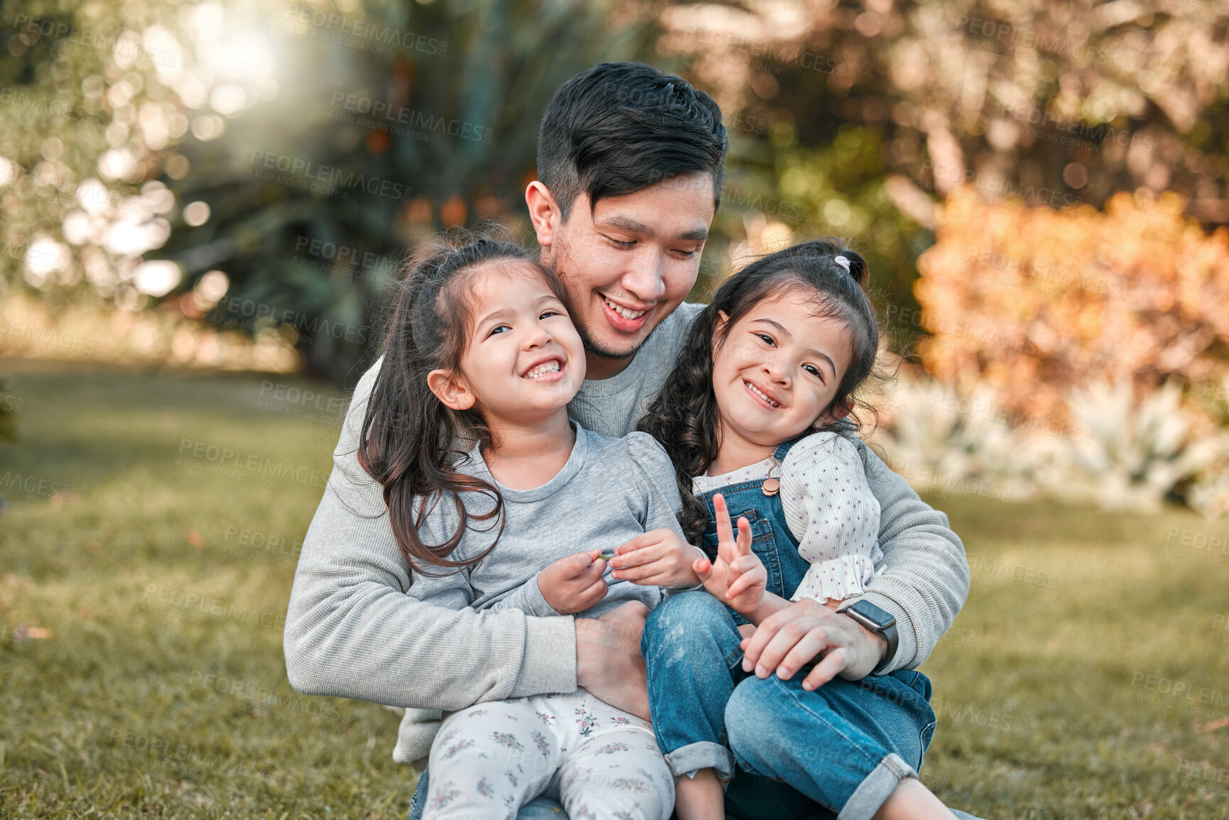 Buy stock photo Shot of a father bonding with his two young daughters outside