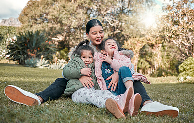 Buy stock photo Shot of a woman sitting outside with her two daughters