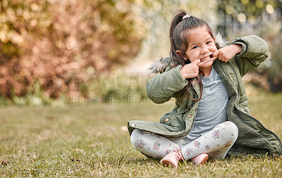Buy stock photo Shot of an adorable little girl sitting outside
