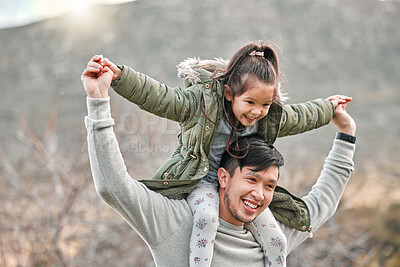 Buy stock photo Shot of a man carrying his daughter on his shoulders