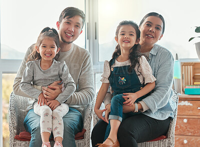 Buy stock photo Shout of a couple sitting at home with their two daughters