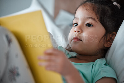 Buy stock photo Reading, book and asian girl on bed for education, learning or language development in bedroom. Knowledge, literacy and child with lying down for information, fairytale story or entertainment in home