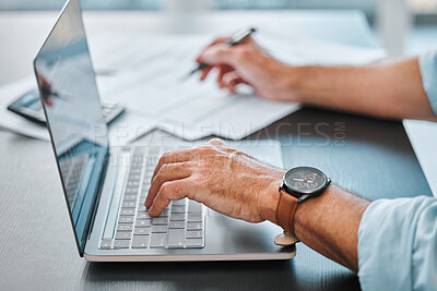 Buy stock photo Cropped shot of an unrecognisable businessman sitting alone in his office and using his laptop while calculating his finances