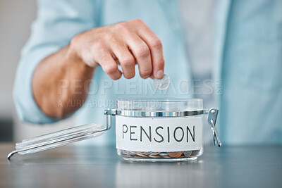 Buy stock photo Cropped shot of an unrecognisable man sitting alone at home and putting money aside for his pension