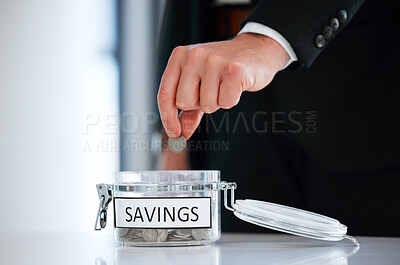 Buy stock photo Shot of a unrecognizable man saving coins in a jar in a office