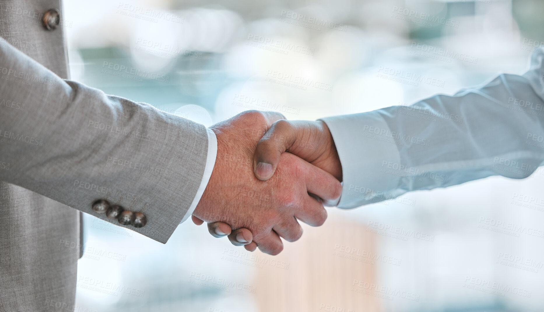Buy stock photo Shot of two unrecognizable males shaking hands in a office