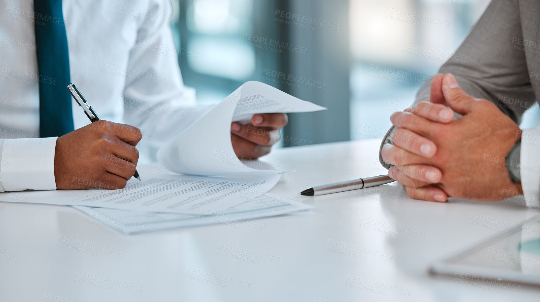 Buy stock photo Shot of two unrecognizable males signing a contract in a office