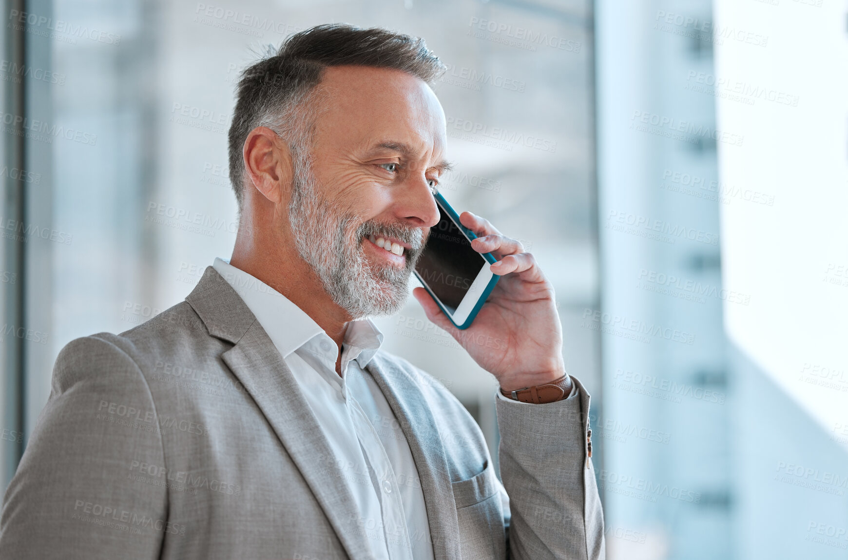Buy stock photo Shot of a businessman on a call at work in a office