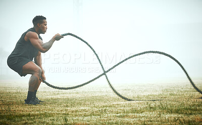 Buy stock photo Exercise, battle rope and black man on field for power workout for body building, training and muscle strength. Fitness, sports and bodybuilder on grass with ropes, energy and outdoor sport in mockup