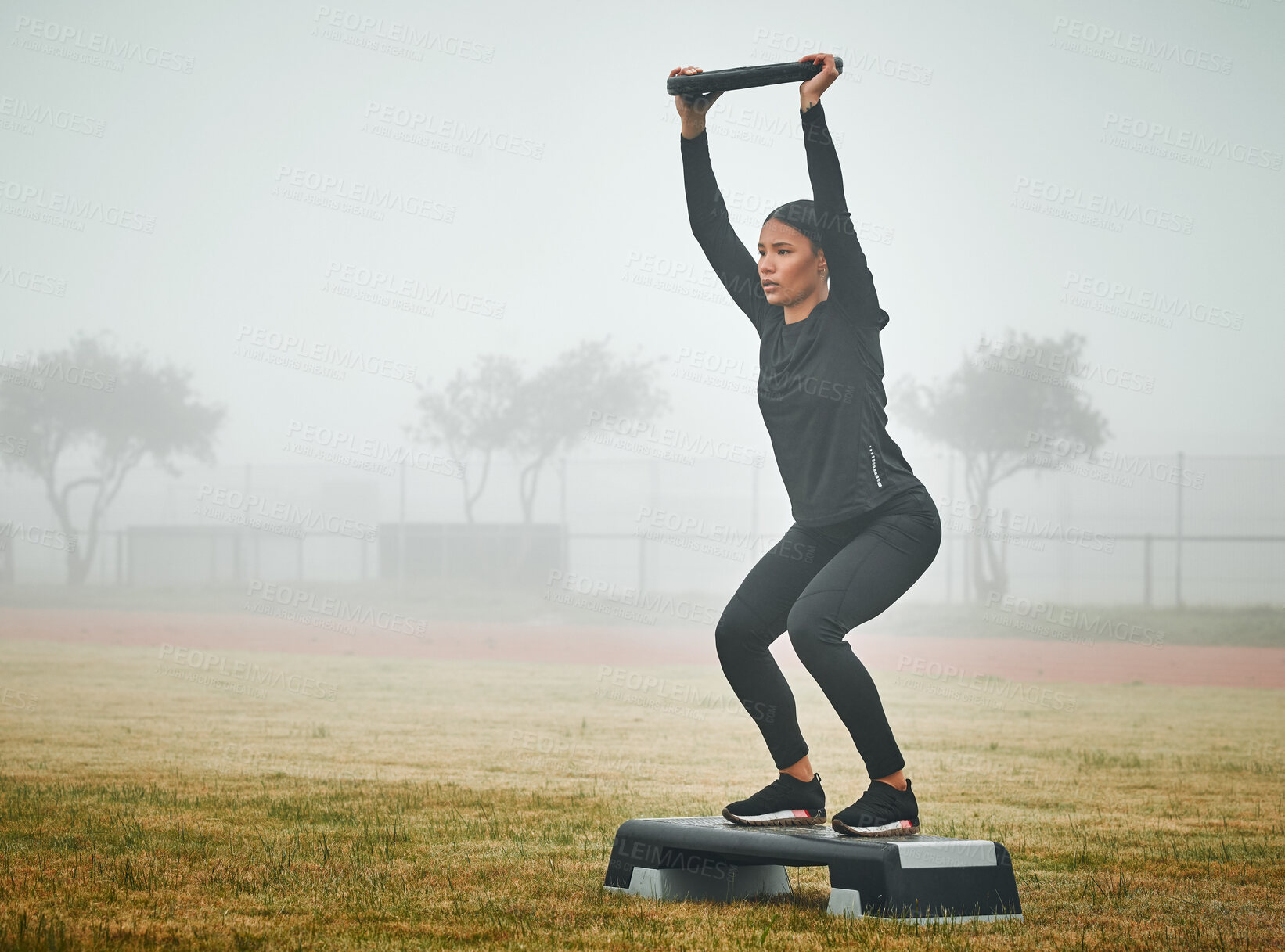 Buy stock photo Woman, exercise and weightlifting with plate on grass, step and balance with power, challenge and fitness. Person, bodybuilder and squat with workout, exercise and training on field in Colombia