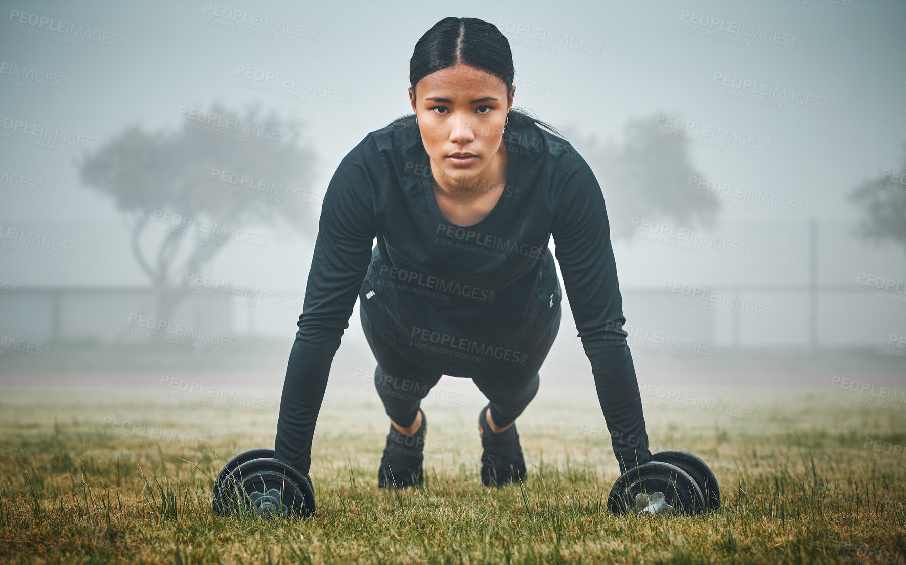 Buy stock photo Portrait, push ups and woman with dumbbells in outdoor for cardio workout, endurance challenge or muscle growth. Field, fitness and athlete on floor for performance, training or strength exercise