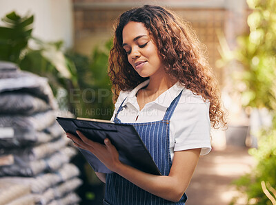 Buy stock photo Shot of a nursery owner doing stock take