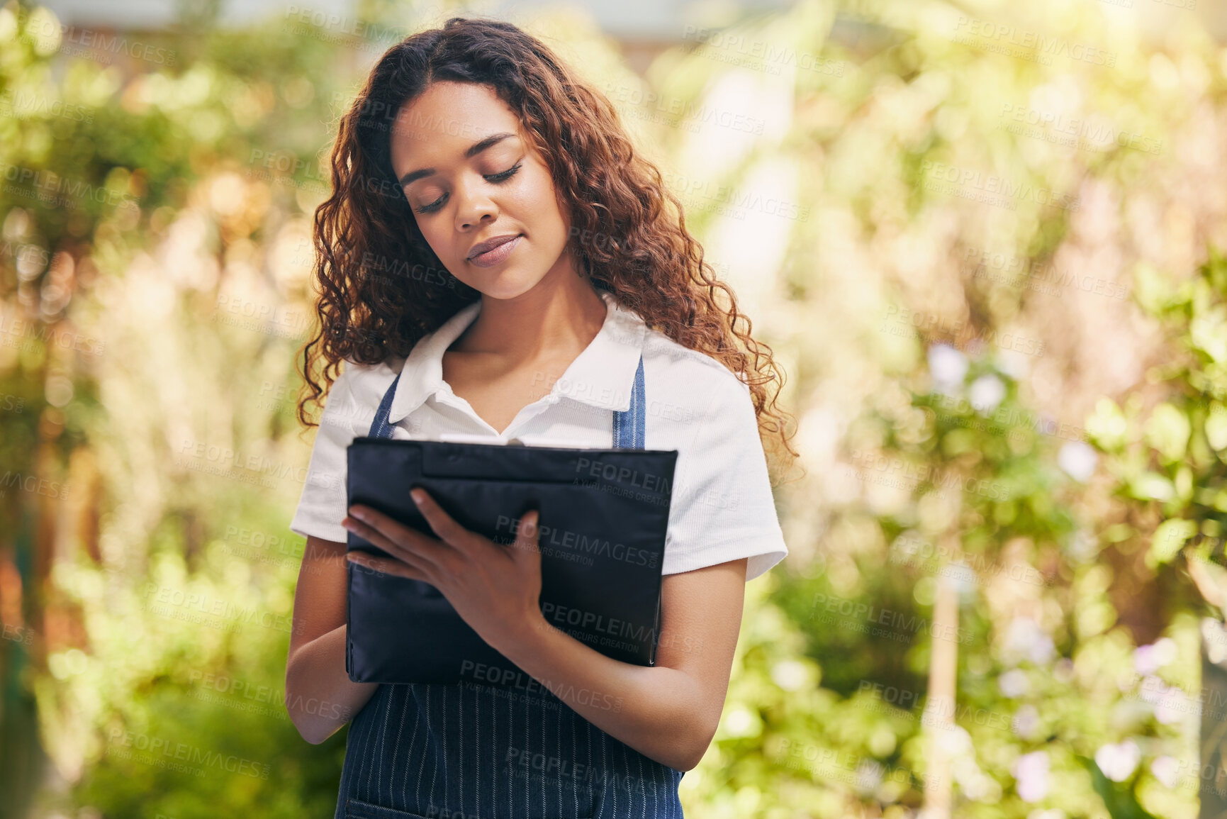 Buy stock photo Woman, florist and writing on clipboard in garden for stock, plants or sustainable growth at store. Person, checklist and check stats with notes, ideas or progress with review at eco friendly nursery