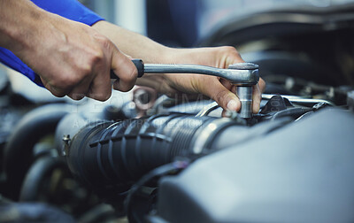 Buy stock photo Cropped shot of an unrecognizable male mechanic working on the engine of a car during a service