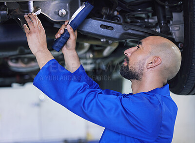 Buy stock photo Man, mechanic and checking vehicle with light for inspection, service or repair at workshop. Young male person or mechanical engineer looking under car for parts, fixing or maintenance at garage