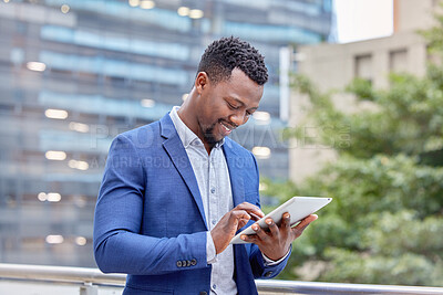 Buy stock photo Shot of a young businessman using a digital tablet against a city background