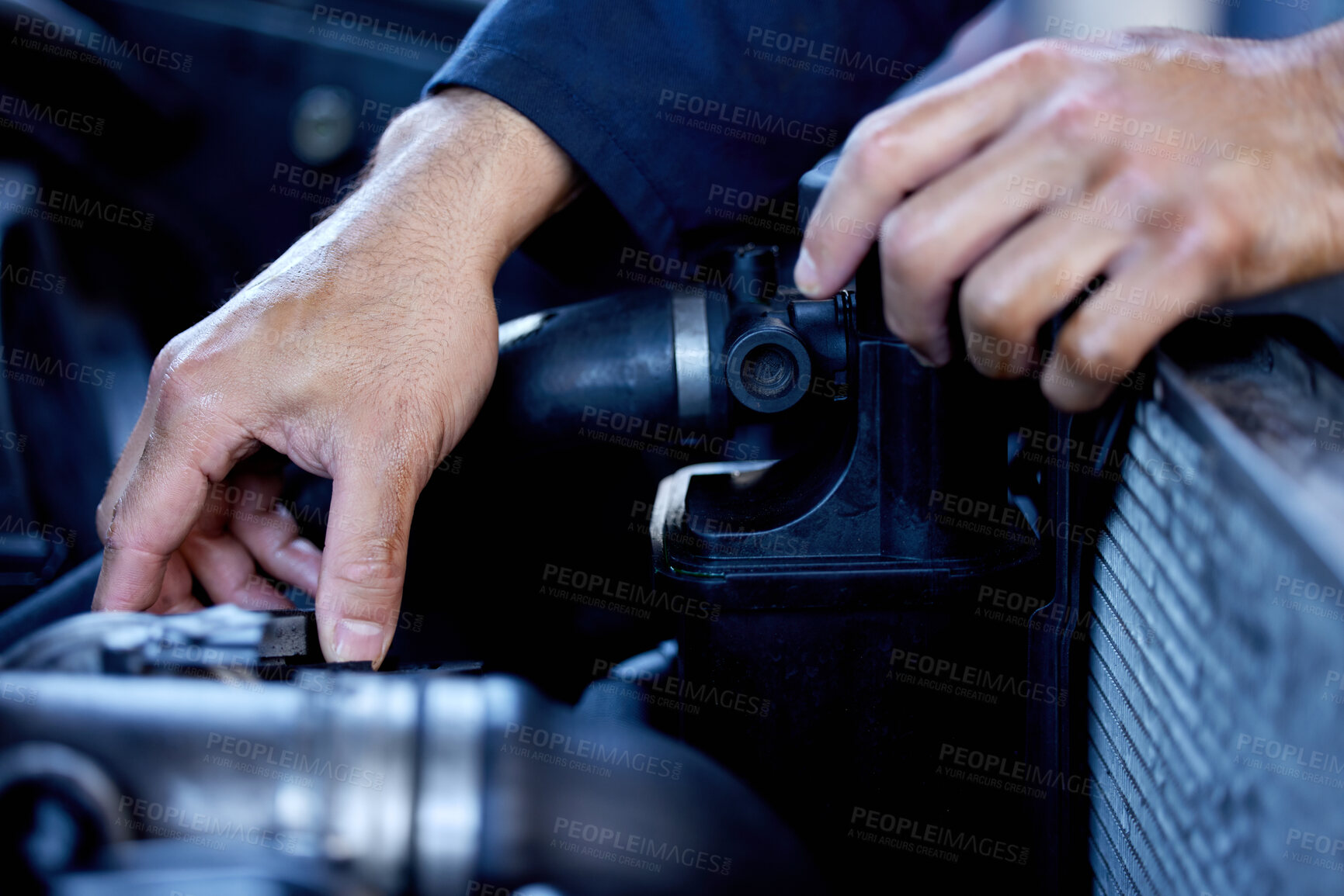 Buy stock photo Cropped shot of an unrecognizable male mechanic working on the engine of a car during a service