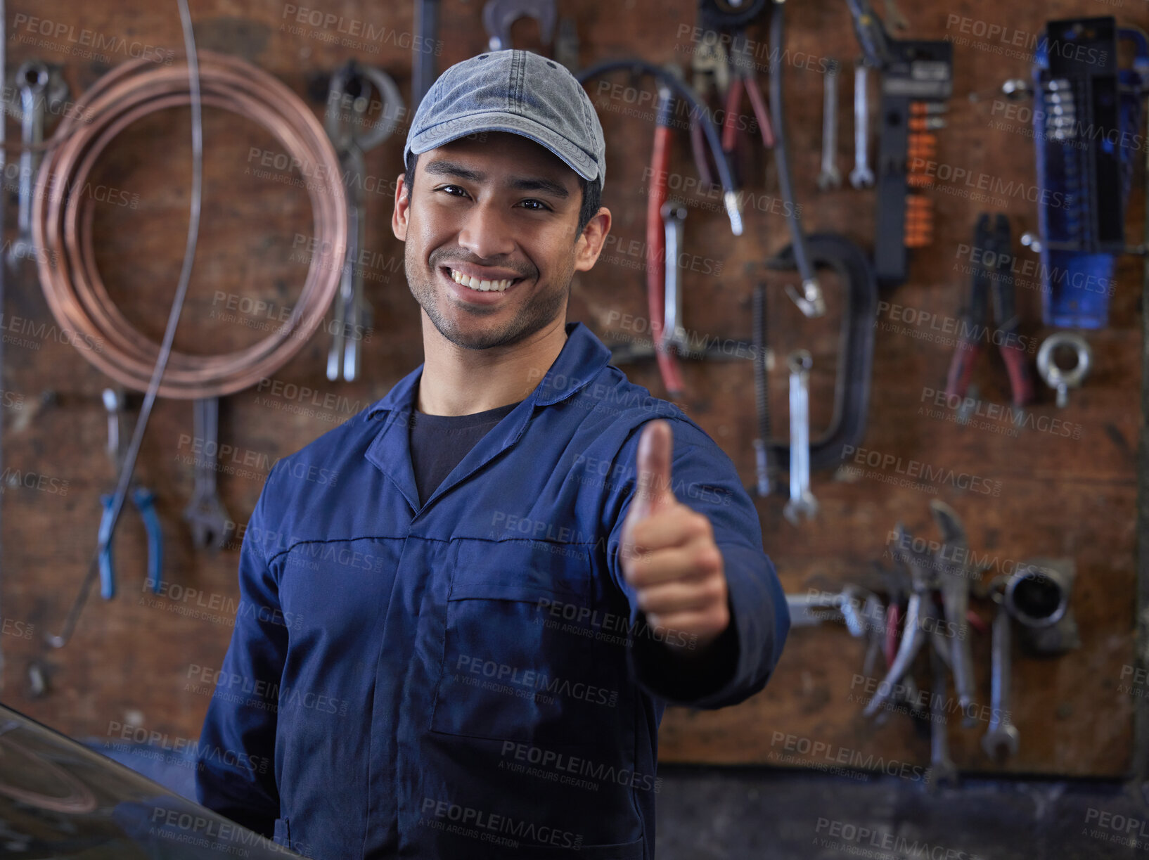 Buy stock photo Mechanic, man and portrait in workshop or thumbs up, repair garage and automotive engineering for car maintenance. Professional, vehicle service and motor issues, confident employee and coveralls