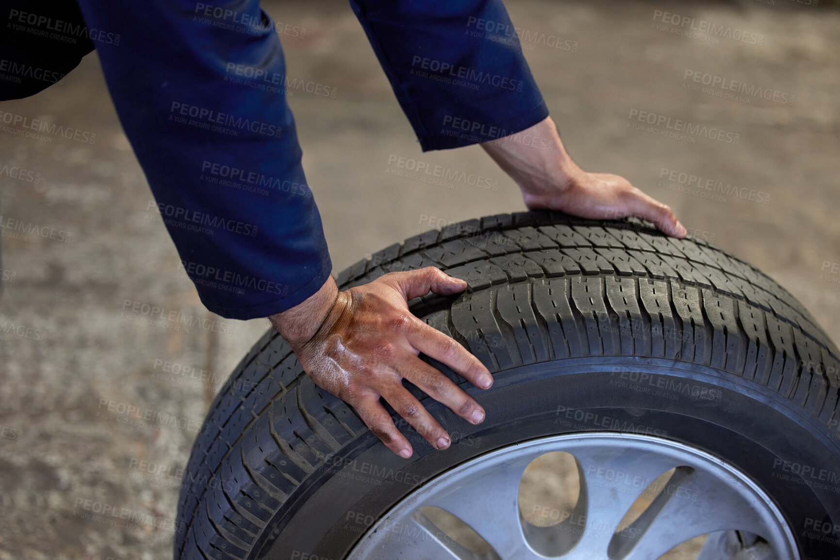 Buy stock photo Mechanic, garage and man working with tyres, repair garage and automotive engineering for car maintenance. Professional, vehicle service and spare wheel change, alignment and pressure in workshop