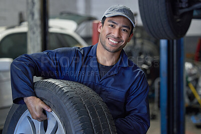 Buy stock photo Man, mechanic and car maintenance with tire change for fixing wheel in garage for vehicle repairs. Male person or technician and smile for motor inspection, road validation and routine service