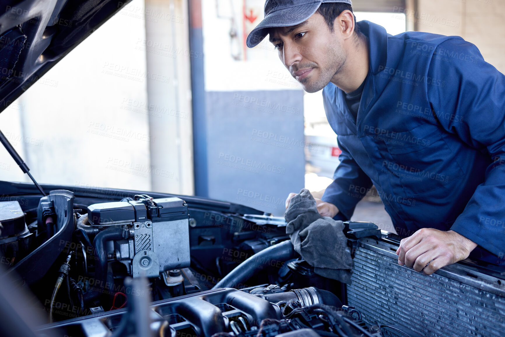 Buy stock photo Man, inspection and engine with cloth for service in garage, workshop or maintenance on car. Male mechanic, auto and check for problem with oil or motor, technician with knowledge on transport