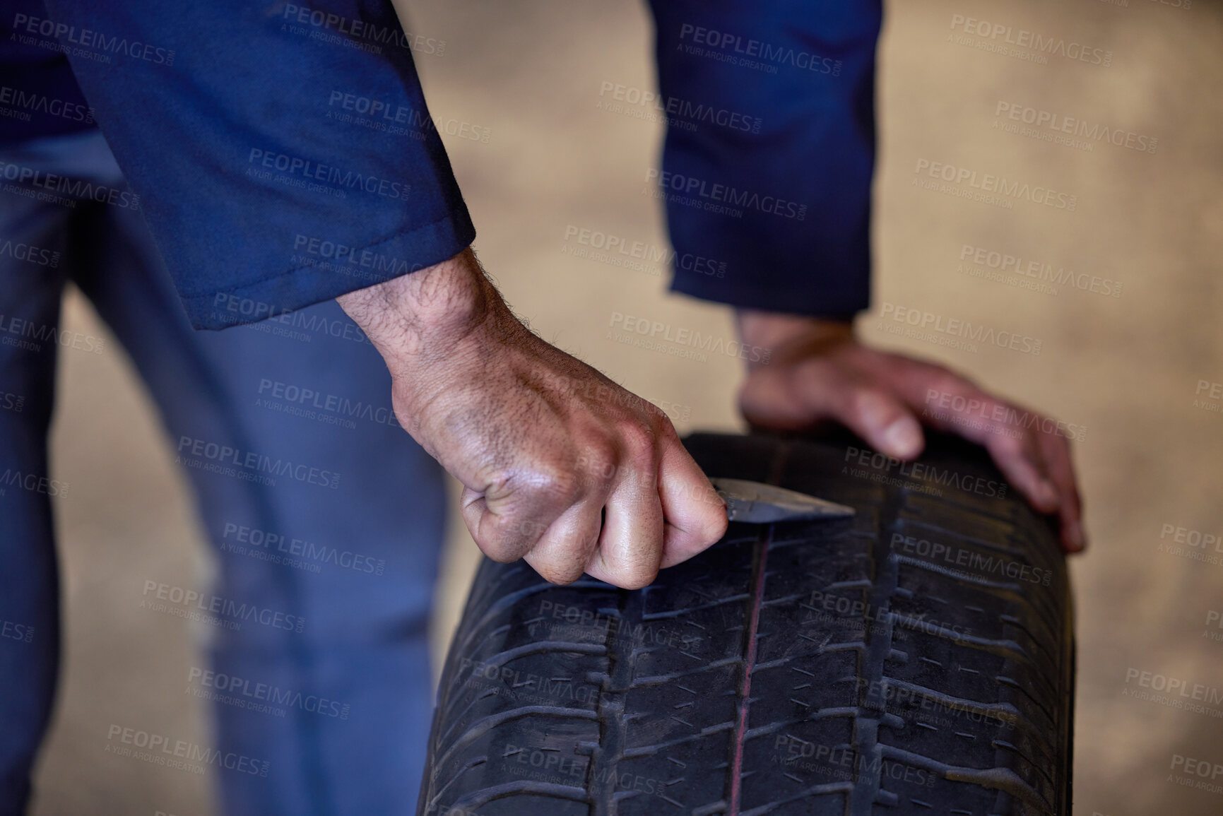 Buy stock photo Mechanic, hand and tire with knife in workshop for maintenance, service and job in motor industry. Garage, man and worker with tool in car factory for automobile, inspection and repair of puncture