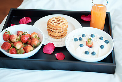 Buy stock photo Breakfast, food or plate in bedroom for nutrition, diet and comfort eating on weekend morning. Romance, juice and strawberries together with pancakes in home for health, organic or vegan meal