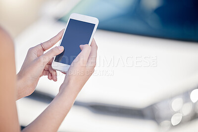 Buy stock photo Shot of an unrecognizable woman using her cellphone while standing outside