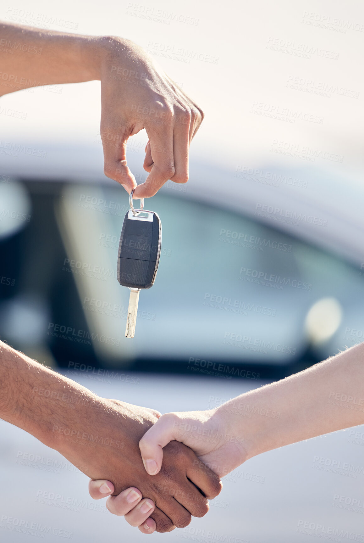 Buy stock photo Shot of a unrecognizable woman shaking hands with a man as she gets a car key outside