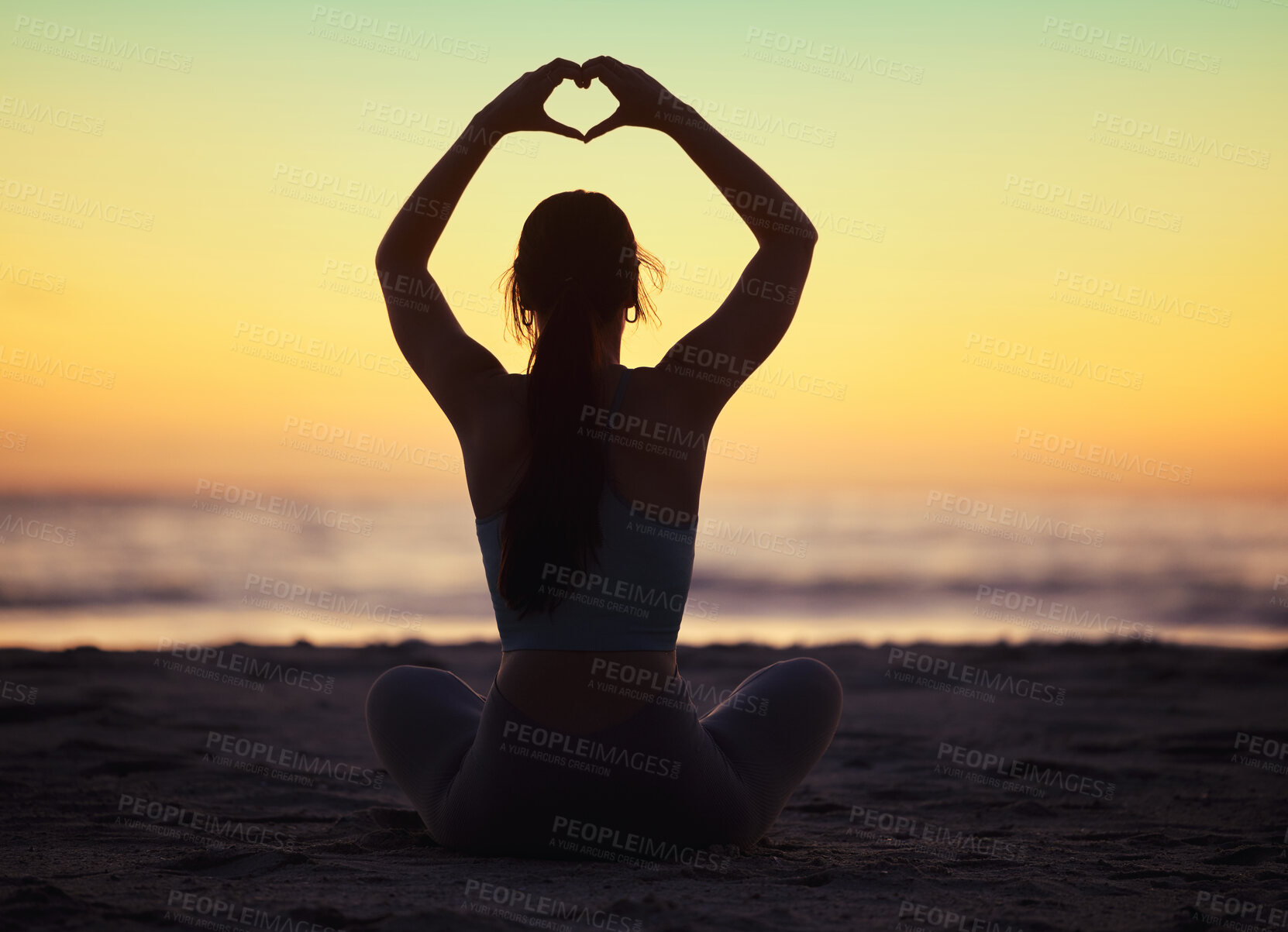 Buy stock photo Woman yoga, heart hand and shadow at sunset at beach and ocean with peace and zen hands sign. Silhouette, nature and sea on a vacation with calm meditation and love emoji gesture outdoor at sunrise