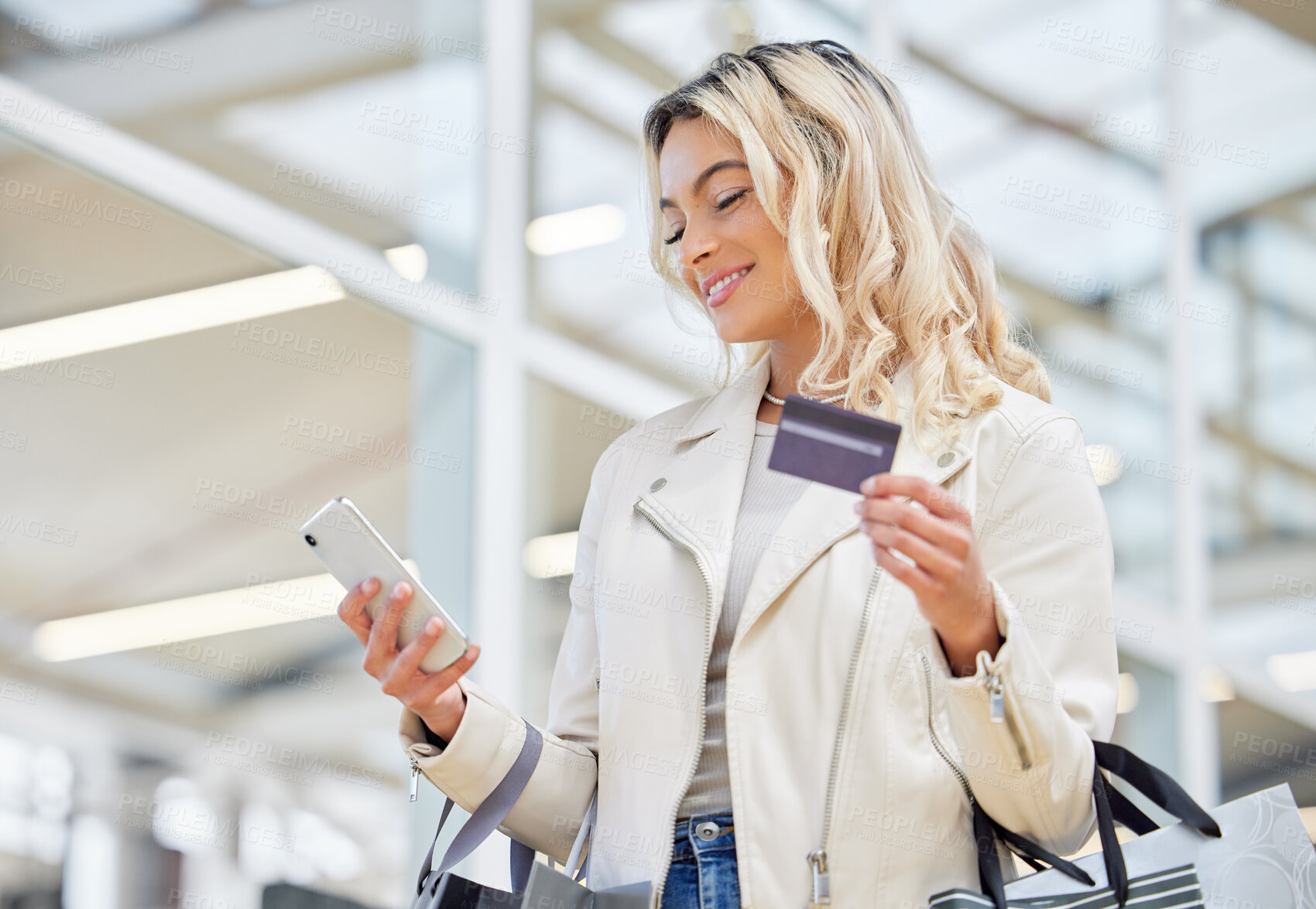 Buy stock photo Credit card, phone and a woman doing online shopping at a mall for retail sale and discount. Happy, ecommerce and a girl with easy pay on a mobile app while in a shop for a deal, payment or bag