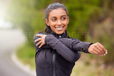 Buy stock photo Shot of a young woman stretching before a jog