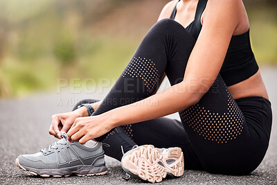 Buy stock photo Fitness, woman tying sneakers and sitting on road for safety during outdoor marathon training. Running, cardio health and wellness, female athlete fixing laces on footwear and runner shoes on asphalt