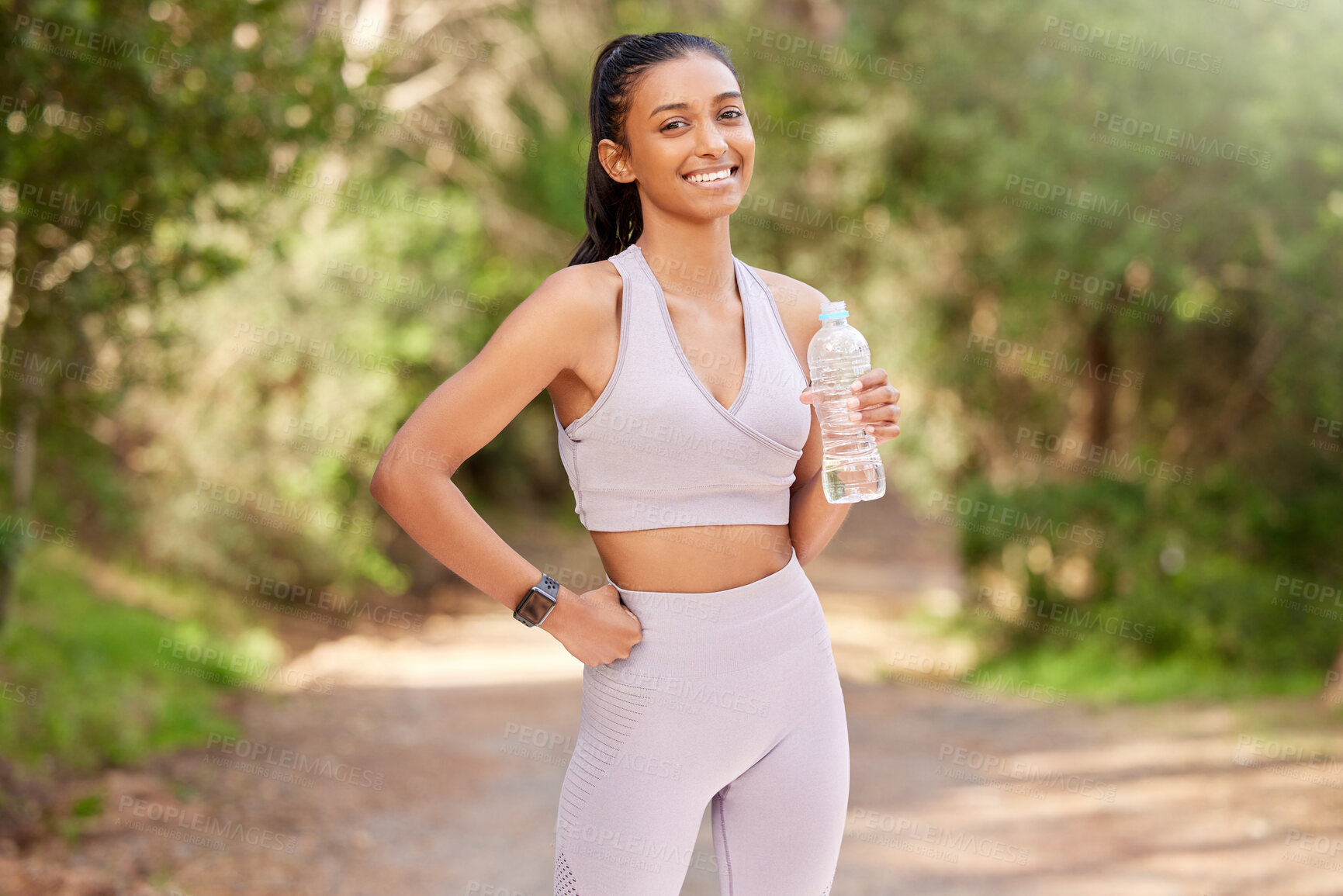 Buy stock photo Woman, bottle and outdoor in portrait with smile for exercise, workout or running in the forest. Happy, female person or  athlete in nature for fitness, training and health with water drink to relax