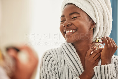 Buy stock photo Shot of a young woman looking cheerful while using perfume