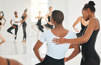 Buy stock photo Shot of a young woman teaching a young boy ballet in a dance studio