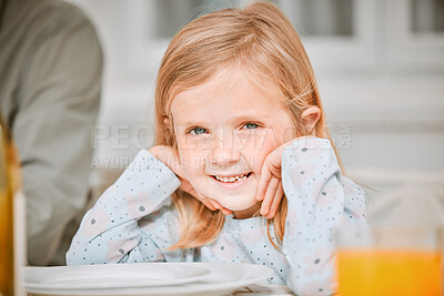 Buy stock photo Shot of a little girl sitting at a tablet with her family at home